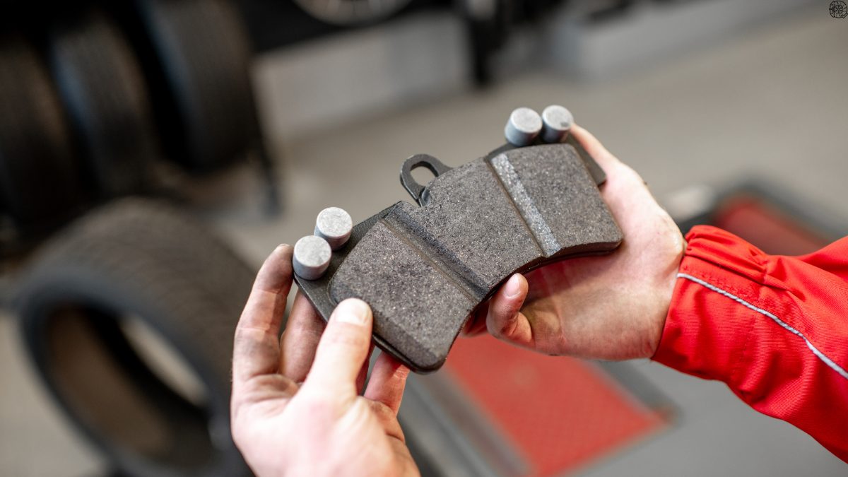 A set of brake pads held up close